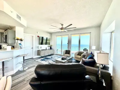 a living room with a couch and a table at Calypso 3-2112 by Emerald Coast Retreats in Panama City Beach