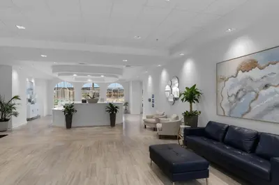 a lobby with a couch and chairs in a building at Calypso 3-2112 by Emerald Coast Retreats in Panama City Beach