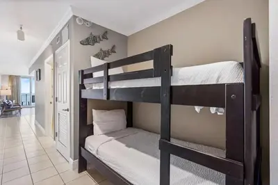 a bedroom with two bunk beds in a room at Emerald Beach Resort 1133 - Beachfront with Breathtaking Views by Beach Haven Vacation Rentals in Panama City Beach