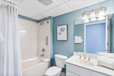 a bathroom with a white toilet and a sink at Emerald Beach Resort 1133 - Beachfront with Breathtaking Views by Beach Haven Vacation Rentals in Panama City Beach