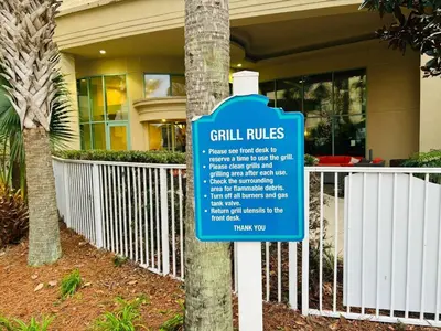 a blue sign in front of a building at Emerald Beach Resort 1133 - Beachfront with Breathtaking Views by Beach Haven Vacation Rentals in Panama City Beach