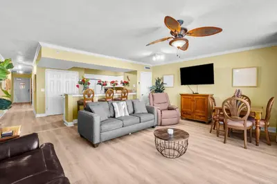 a living room with a couch and a tv at Emerald Beach Resort 1834 - Beachfront with Stunning Views by Beach Haven Vacation Rentals in Panama City Beach