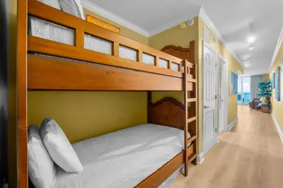 two bunk beds in a room with a hallway at Emerald Beach Resort 1834 - Beachfront with Stunning Views by Beach Haven Vacation Rentals in Panama City Beach