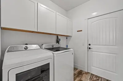 a white laundry room with a washer and dryer at Nothin But Time by Beach Haven Vacation Rentals in Panama City Beach