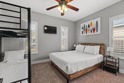 a bedroom with a bed and a ceiling fan at Nothin But Time by Beach Haven Vacation Rentals in Panama City Beach
