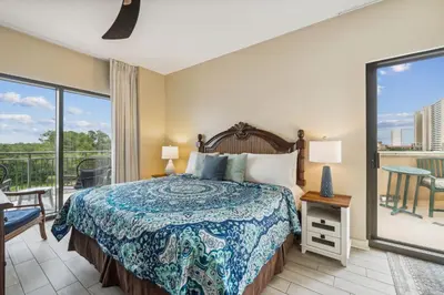 a bedroom with a bed and a balcony at Origin 0427 - One Bedroom - Partial Gulf View by Beach Haven Vacation Rentals in Panama City Beach
