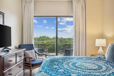 a hotel room with a bed and a balcony at Origin 0427 - One Bedroom - Partial Gulf View by Beach Haven Vacation Rentals in Panama City Beach