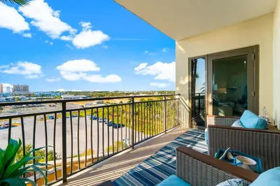 a balcony with a view of the ocean at Origin 0507- One Bedroom - Sunset and Gulf Views! by Beach Haven Vacation Rentals in Panama City Beach