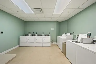 a room with white appliances in a room with blue walls at Origin 0513 - Studio King - City View with a Great Value by Beach Haven Vacation Rentals in Panama City Beach