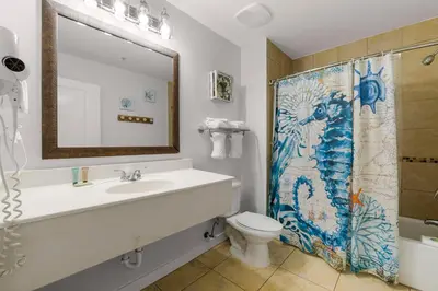 a bathroom with a sink and a shower curtain at Origin 0513 - Studio King - City View with a Great Value by Beach Haven Vacation Rentals in Panama City Beach