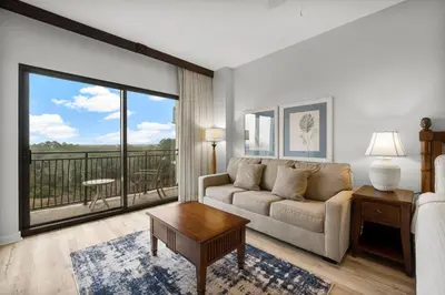 a living room with a couch and a large window at Origin 0513 - Studio King - City View with a Great Value by Beach Haven Vacation Rentals in Panama City Beach