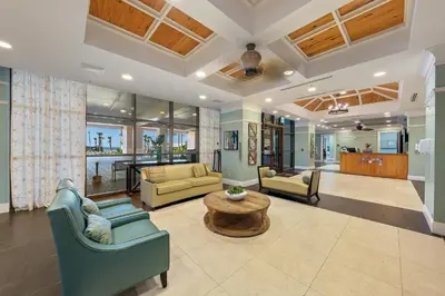 a living room with two couches and a table at Origin 0517 - One Bedroom - Partial Gulf View by Beach Haven Vacation Rentals in Panama City Beach