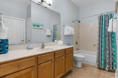 a bathroom with a sink and a toilet and a tub at The Village Blue Haven Condo - Private Beach Access Pool & Hot Tub in Rosemary Beach