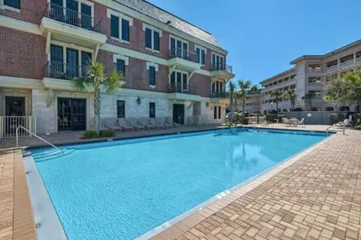 a large swimming pool in front of a building at The Village Blue Haven Condo - Private Beach Access Pool & Hot Tub in Rosemary Beach