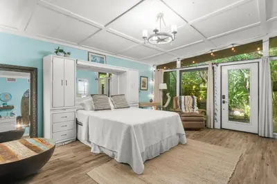 a bedroom with a bed and a mirror at Zen Studio by Beach Haven Vacation Rentals in Panama City Beach