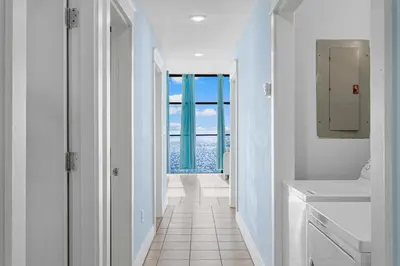 a white bathroom with a view of the ocean at Tiki Time 702 by Beach Haven Vacation Rentals in Panama City Beach