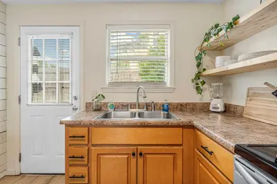 a kitchen with a sink and a window at The Yard by Beach Haven Vacation Rentals in Panama City Beach