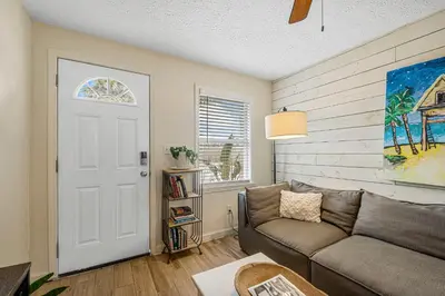 a living room with a couch and a door at The Yard by Beach Haven Vacation Rentals in Panama City Beach