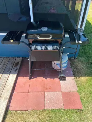 a grill sitting on a table with drinks on it at Surf Shack - Steps to the beach, lush fenced backyard by Beach Haven Vacation Rentals in Panama City Beach