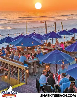 a group of people sitting at tables with umbrellas on the beach at Surf Shack - Steps to the beach, lush fenced backyard by Beach Haven Vacation Rentals in Panama City Beach