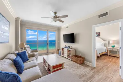 a living room with a couch and a tv at Sunrise Beach - 1610 by Beach Haven Vacation Rentals in Panama City Beach