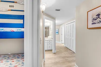 a bedroom with a bed and a bathroom at Sunrise Beach - 1610 by Beach Haven Vacation Rentals in Panama City Beach