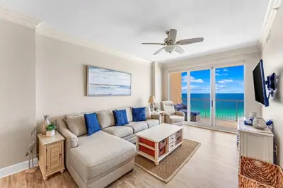 a living room with a couch and a tv at Sunrise Beach - 1610 by Beach Haven Vacation Rentals in Panama City Beach