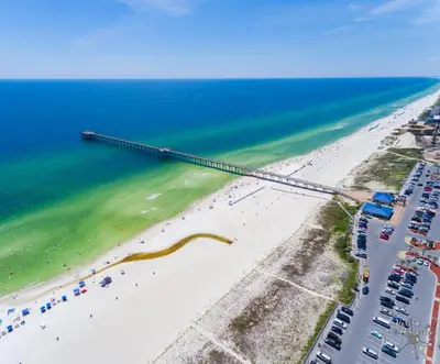 an aerial view of a beach with a pier at Sunny Daze Cottage by Beach Haven Vacation Rentals in Panama City Beach