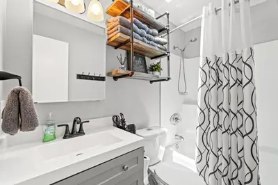 a bathroom with a sink and a shower curtain at Sunny Daze Cottage by Beach Haven Vacation Rentals in Panama City Beach