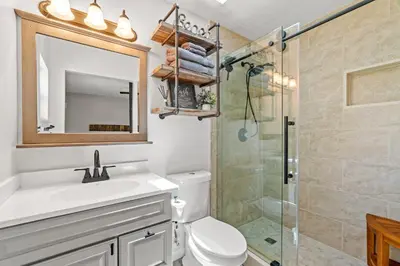 a bathroom with a toilet and a sink and a shower at Sunny Daze Cottage by Beach Haven Vacation Rentals in Panama City Beach