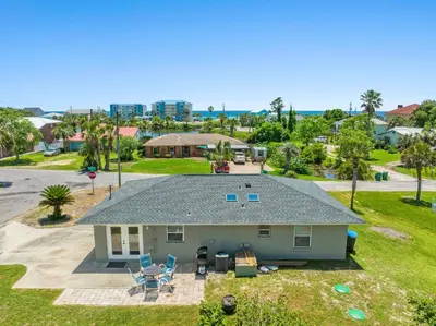 an aerial view of a house with a backyard at Sunny Daze Cottage by Beach Haven Vacation Rentals in Panama City Beach