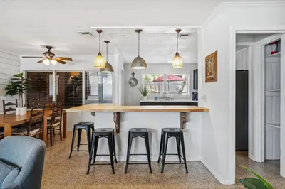a kitchen and dining room with a counter and stools at Summer Haven by Beach Haven Vacation Rentals in Panama City Beach