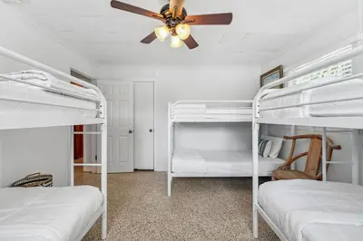 a bedroom with two bunk beds and a ceiling fan at Summer Haven by Beach Haven Vacation Rentals in Panama City Beach
