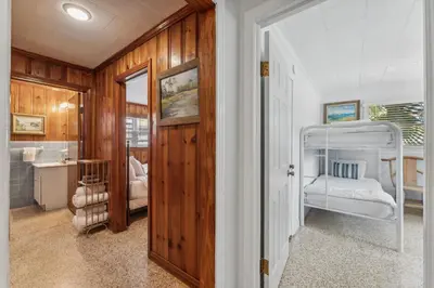 a bedroom with a bunk bed and a bathroom at Summer Haven by Beach Haven Vacation Rentals in Panama City Beach