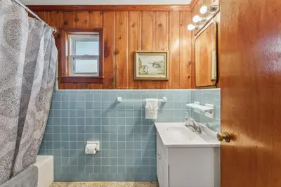 a blue tiled bathroom with a sink and a shower at Summer Haven by Beach Haven Vacation Rentals in Panama City Beach
