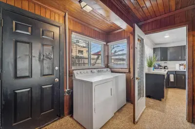 a washer and dryer in a kitchen with wooden walls at Summer Haven by Beach Haven Vacation Rentals in Panama City Beach