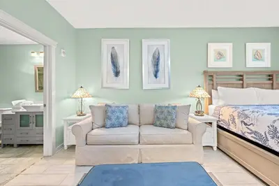 a living room with a couch and a bed at Origin 0615 - Studio King - Stylish Unit with City Views by Beach Haven Vacation Rentals in Panama City Beach