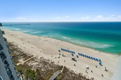 an aerial view of a beach with umbrellas and the ocean at Sterling Breeze 1205 by Beach Haven Vacation Rentals in Panama City Beach