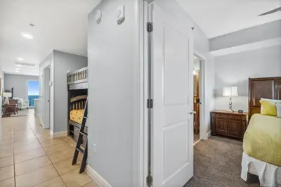 a bedroom with a bed and a bunk bed at Sterling Breeze 1205 by Beach Haven Vacation Rentals in Panama City Beach