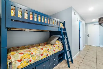 a blue bunk bed in a childs bedroom at Sterling Breeze 1205 by Beach Haven Vacation Rentals in Panama City Beach