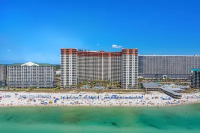 a group of people on a beach in front of a hotel at Shores of Panama 2219 by Beach Haven Vacation Rentals in Panama City Beach