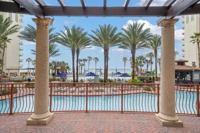 a view of the pool at a resort with palm trees at Shores of Panama 2219 by Beach Haven Vacation Rentals in Panama City Beach
