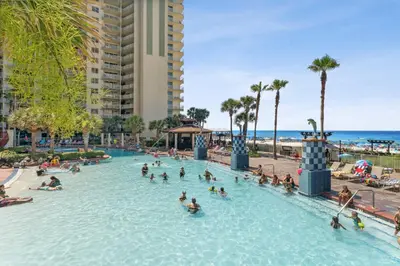 a group of people in a swimming pool at a resort at Shores of Panama 2219 by Beach Haven Vacation Rentals in Panama City Beach