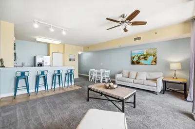 a living room with a couch and a kitchen at Shores of Panama 2219 by Beach Haven Vacation Rentals in Panama City Beach