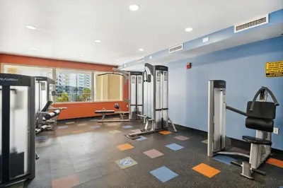 a gym with treadmills and machines in a room at Shores of Panama 2219 by Beach Haven Vacation Rentals in Panama City Beach
