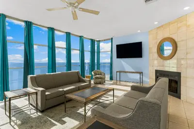 a living room with a couch and a fireplace at Sharkys Retreat 701 by Beach Haven Vacation Rentals in Panama City Beach
