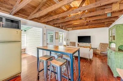 a kitchen and living room with a wooden ceiling at Sea Shed by Beach Haven Vacation Rentals in Panama City Beach