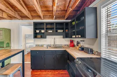 a kitchen with black cabinets and a sink at Sea Shed by Beach Haven Vacation Rentals in Panama City Beach