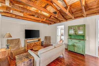 a living room with a couch and a tv at Sea Shed by Beach Haven Vacation Rentals in Panama City Beach