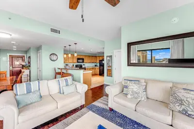 a living room with two couches and a kitchen at Origin 1605 - Two Bedroom - Partial Gulf View by Beach Haven Vacation Rentals in Panama City Beach